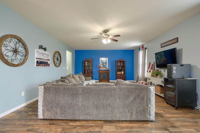 living room with wood-type flooring and ceiling fan