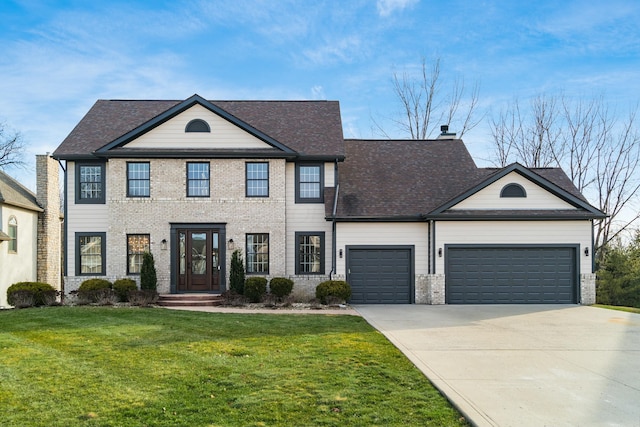 view of front facade with a garage and a front lawn