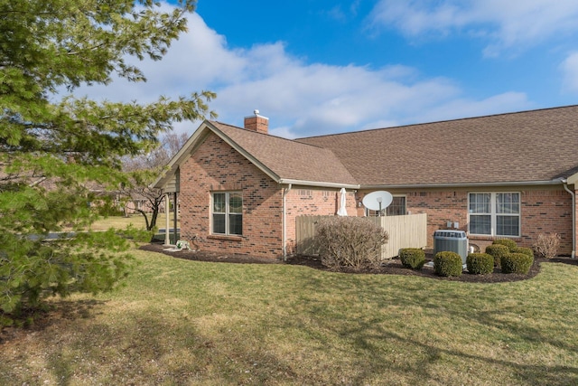 view of property exterior with central AC unit and a lawn