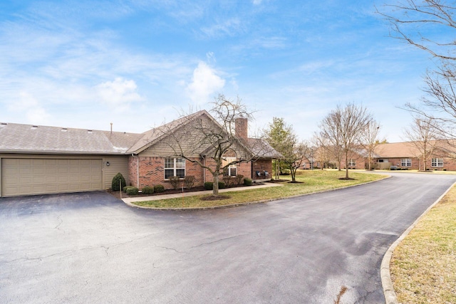 single story home with a garage and a front lawn