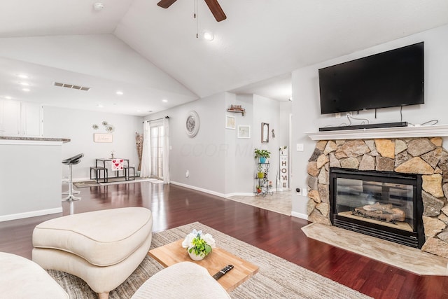 living room featuring a fireplace, wood-type flooring, ceiling fan, and vaulted ceiling