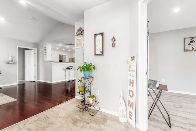 interior space featuring light hardwood / wood-style flooring and vaulted ceiling