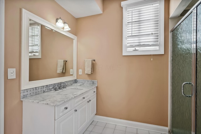 bathroom featuring vanity, an enclosed shower, and tile patterned floors