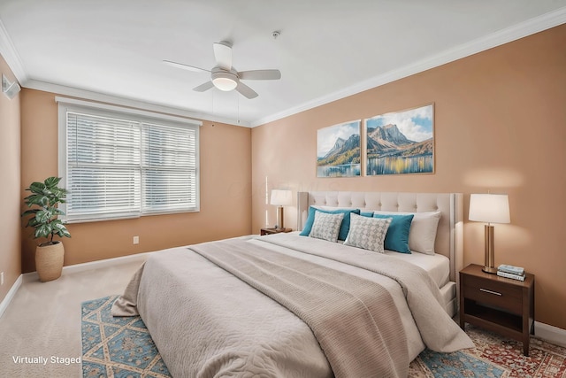 bedroom with crown molding, ceiling fan, and carpet floors