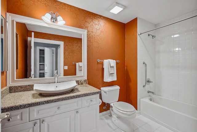 full bathroom featuring tiled shower / bath combo, vanity, tile patterned floors, and toilet