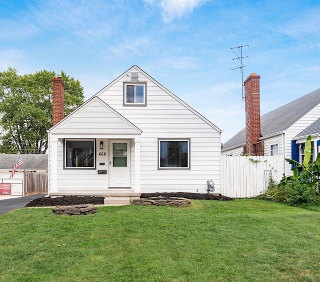 bungalow-style home with a front yard