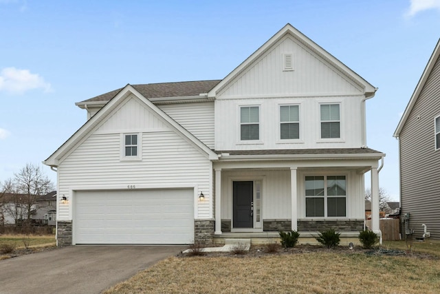 view of front facade with a garage, a porch, and a front lawn