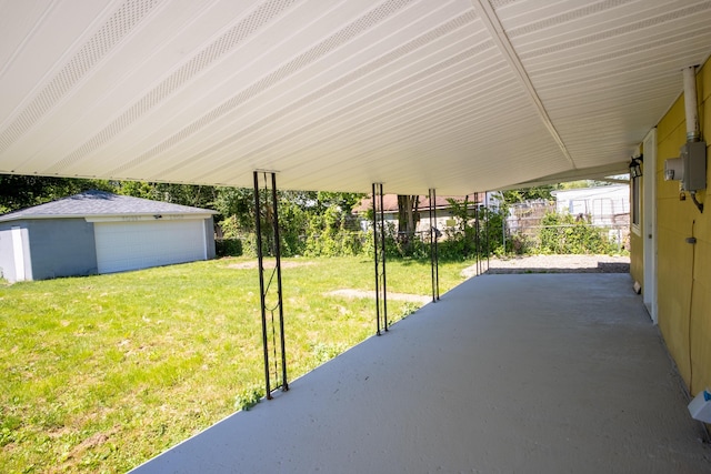 view of patio featuring a garage and an outdoor structure