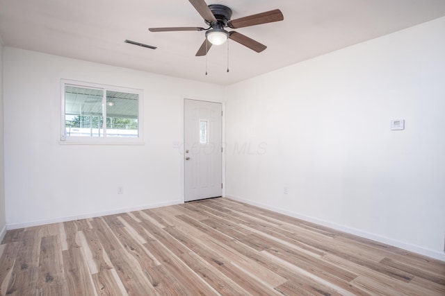 spare room featuring ceiling fan and light hardwood / wood-style floors