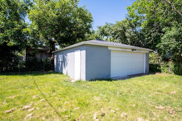 garage featuring a lawn