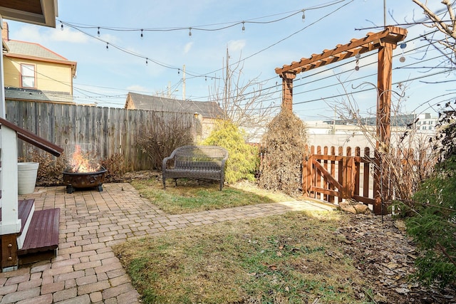 view of yard with a patio and an outdoor fire pit