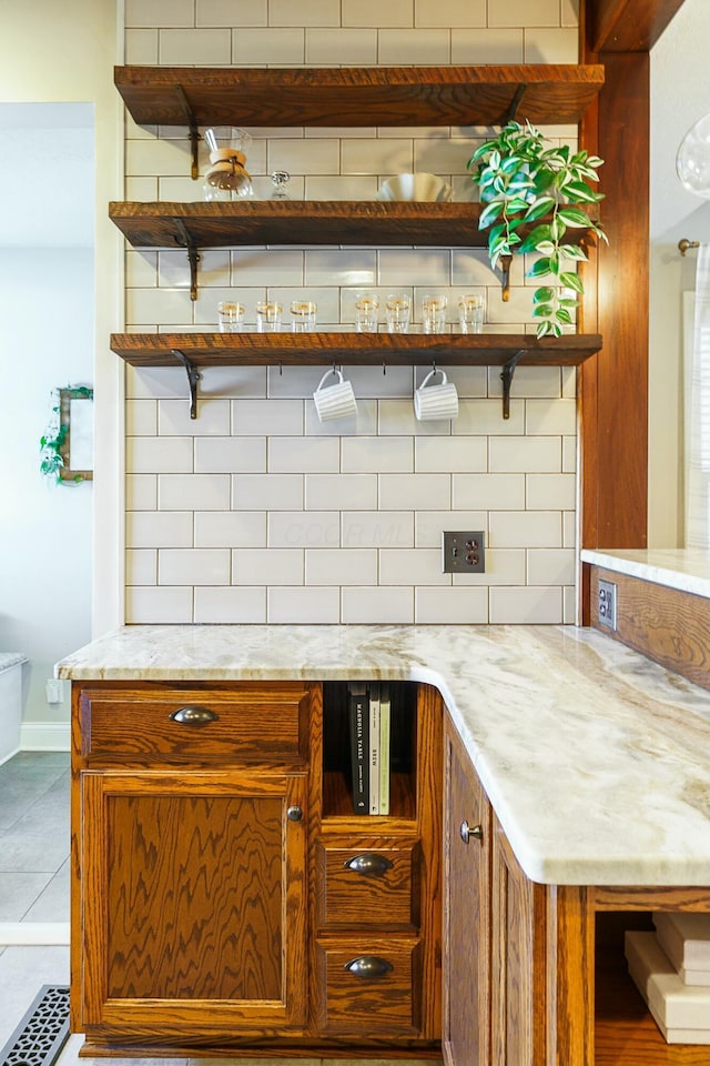 kitchen with light stone counters and light tile patterned floors