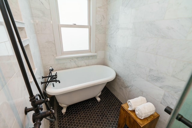 bathroom with tile walls and a bath