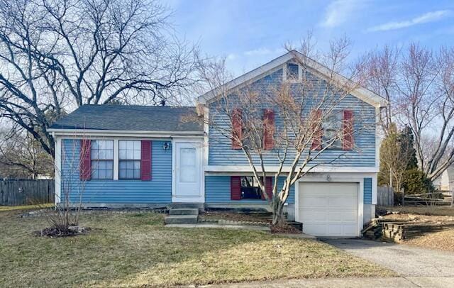 tri-level home featuring a garage and a front yard