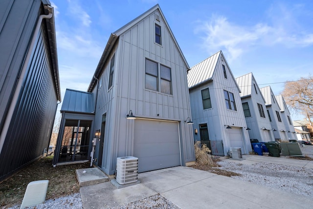 view of front facade with a garage and central AC