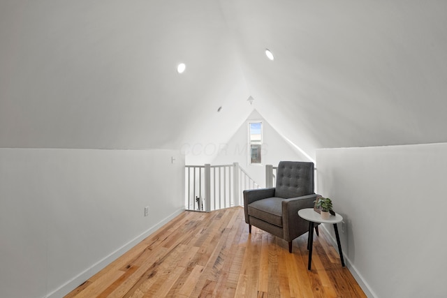 living area with lofted ceiling and light hardwood / wood-style floors