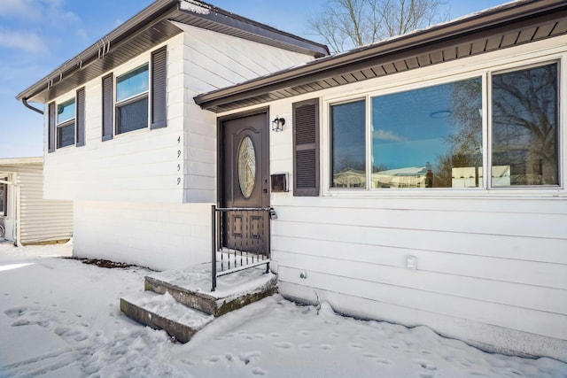 view of snow covered property entrance