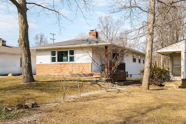 ranch-style house with crawl space, brick siding, and a chimney