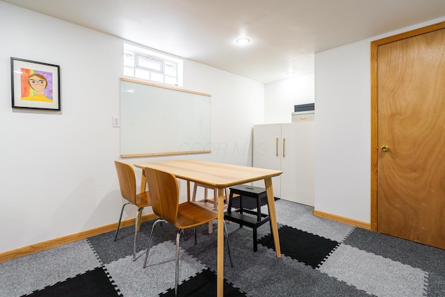 dining area featuring light carpet and baseboards