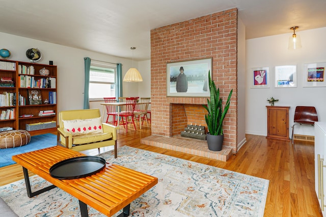 living area with a fireplace and light wood-style floors