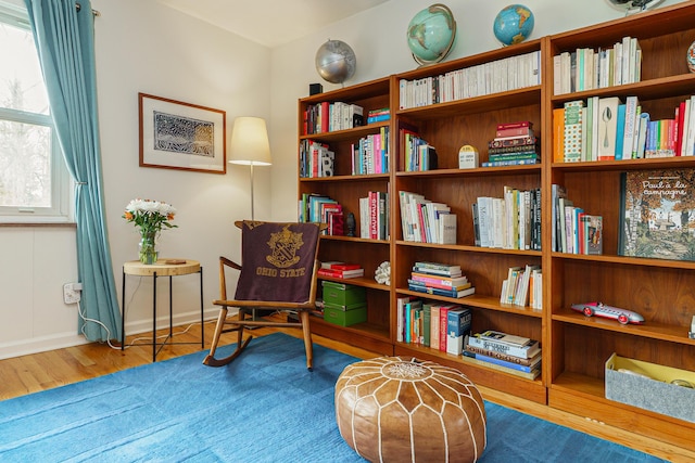 living area featuring wood finished floors and baseboards