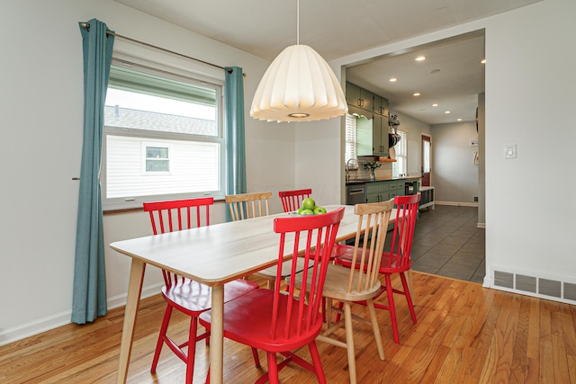 dining space with baseboards, recessed lighting, visible vents, and light wood-style floors