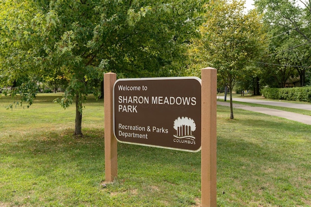 community sign featuring a lawn