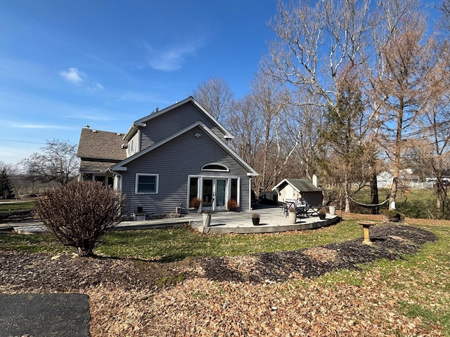 back of property with an outdoor structure and a lawn