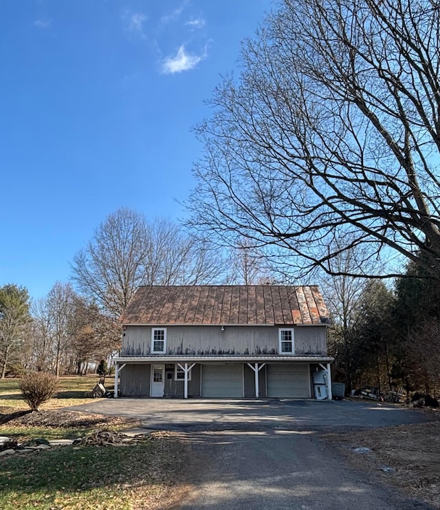 view of front of property featuring aphalt driveway and a garage