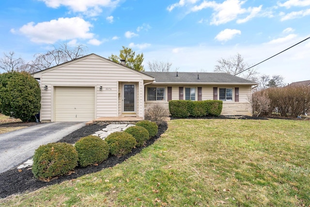 ranch-style home with an attached garage, driveway, and a front yard