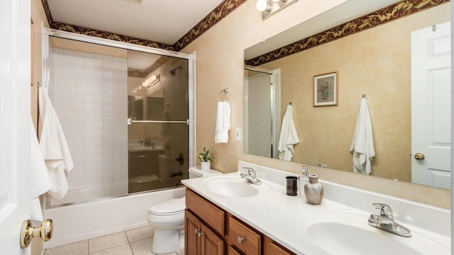 bathroom with toilet, shower / bath combination with glass door, a sink, and tile patterned floors