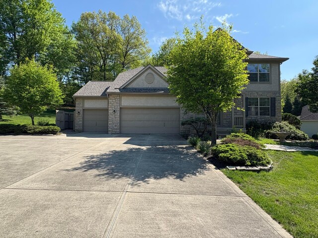 936 Howell Dr, Newark, OH 43055 - view of front of property featuring a garage, concrete driveway, and stone siding