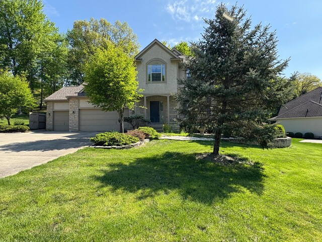 936 Howell Dr, Newark, OH 43055 - view of front facade with a garage, stone siding, concrete driveway, and a front yard