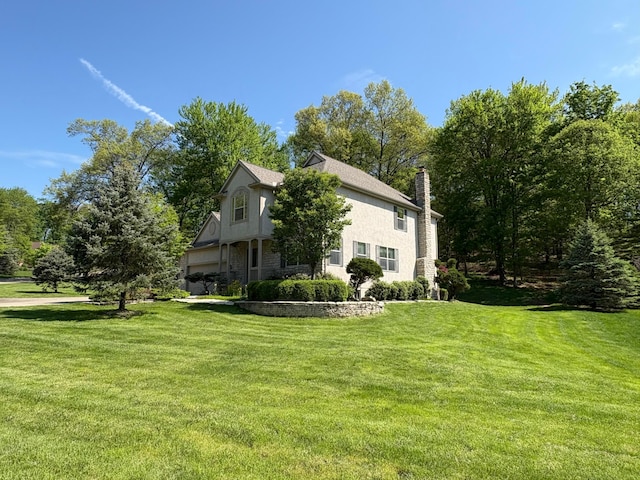 936 Howell Dr, Newark, OH 43055 - view of side of home featuring a lawn, stucco siding, and a chimney