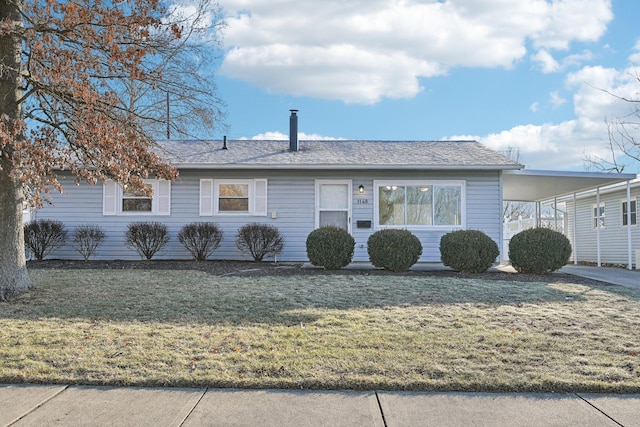 ranch-style home with a front yard and a carport