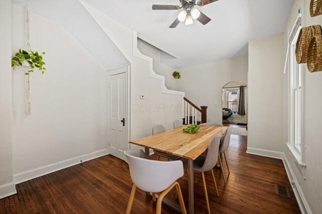 dining room with ceiling fan and dark hardwood / wood-style flooring