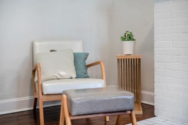 sitting room with radiator heating unit and hardwood / wood-style floors