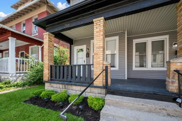 view of exterior entry with covered porch