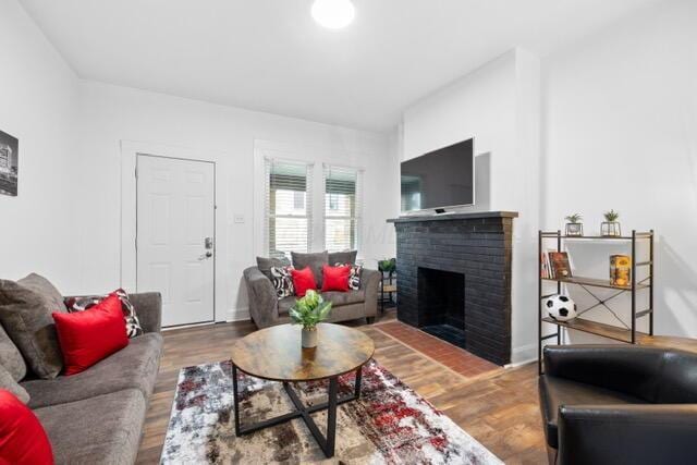 living room with hardwood / wood-style flooring and a fireplace