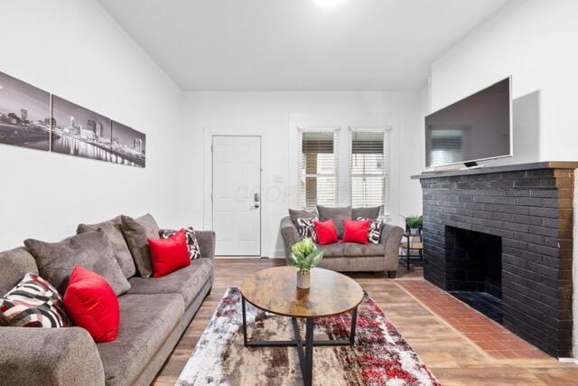 living room with hardwood / wood-style flooring and a fireplace