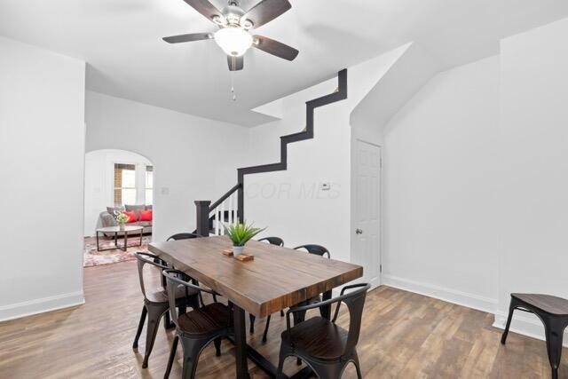 dining area with ceiling fan and wood-type flooring