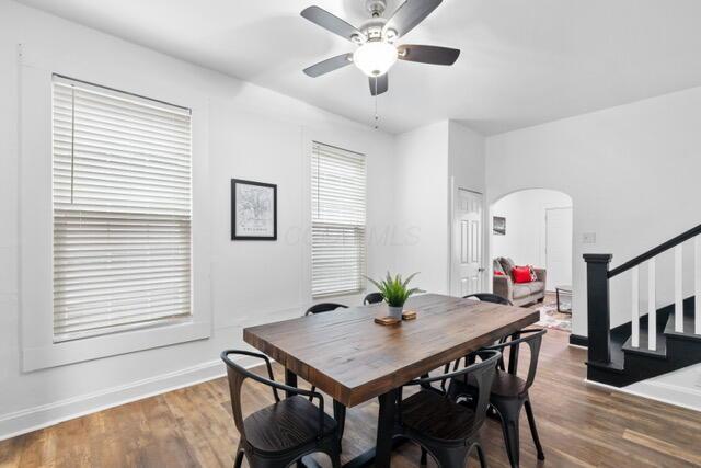 dining space featuring dark wood-type flooring and ceiling fan