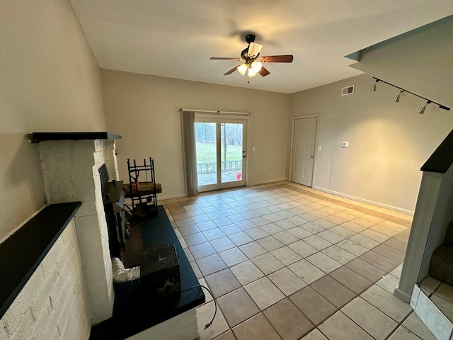 unfurnished living room with light tile patterned flooring and ceiling fan