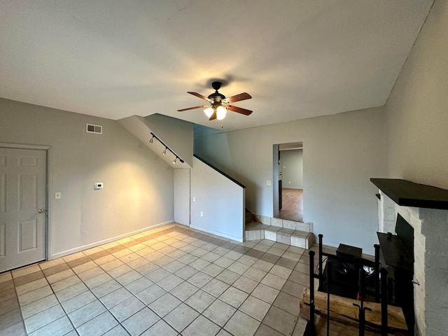 living room with ceiling fan and light tile patterned floors