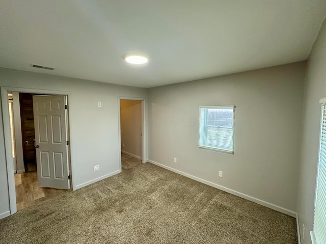 unfurnished bedroom with light colored carpet