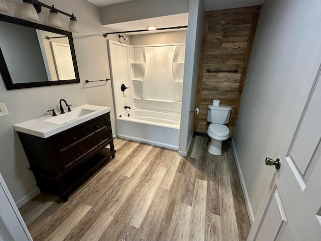 full bathroom with wood-type flooring, toilet, shower / bath combination, and vanity