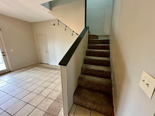 stairs with tile patterned floors