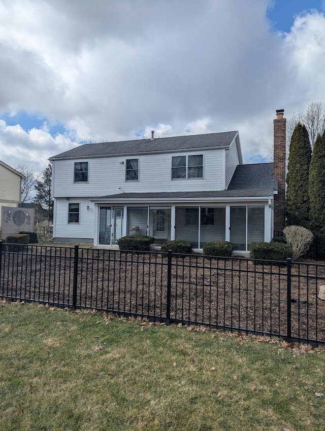 rear view of property with a fenced front yard and a chimney