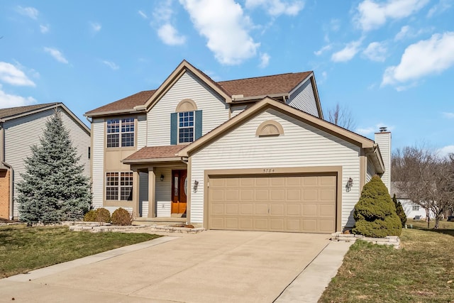 traditional home with a shingled roof, a front yard, concrete driveway, and an attached garage