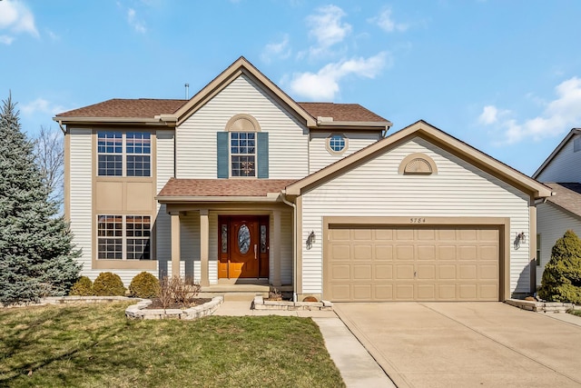 traditional-style home with a garage, concrete driveway, a front lawn, and a shingled roof